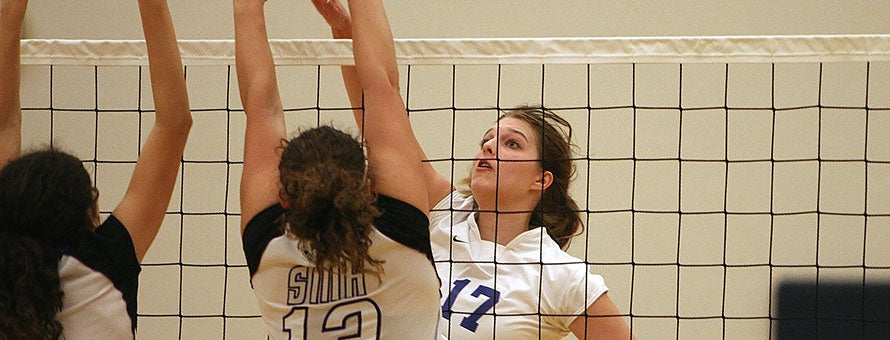 two teams competing in a volleyball game