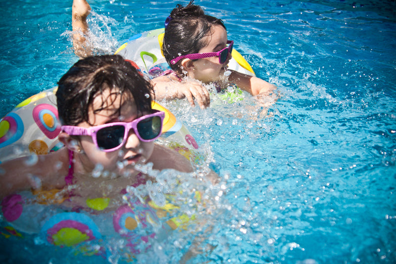 Kids in Pool Floats Swimming in Pool