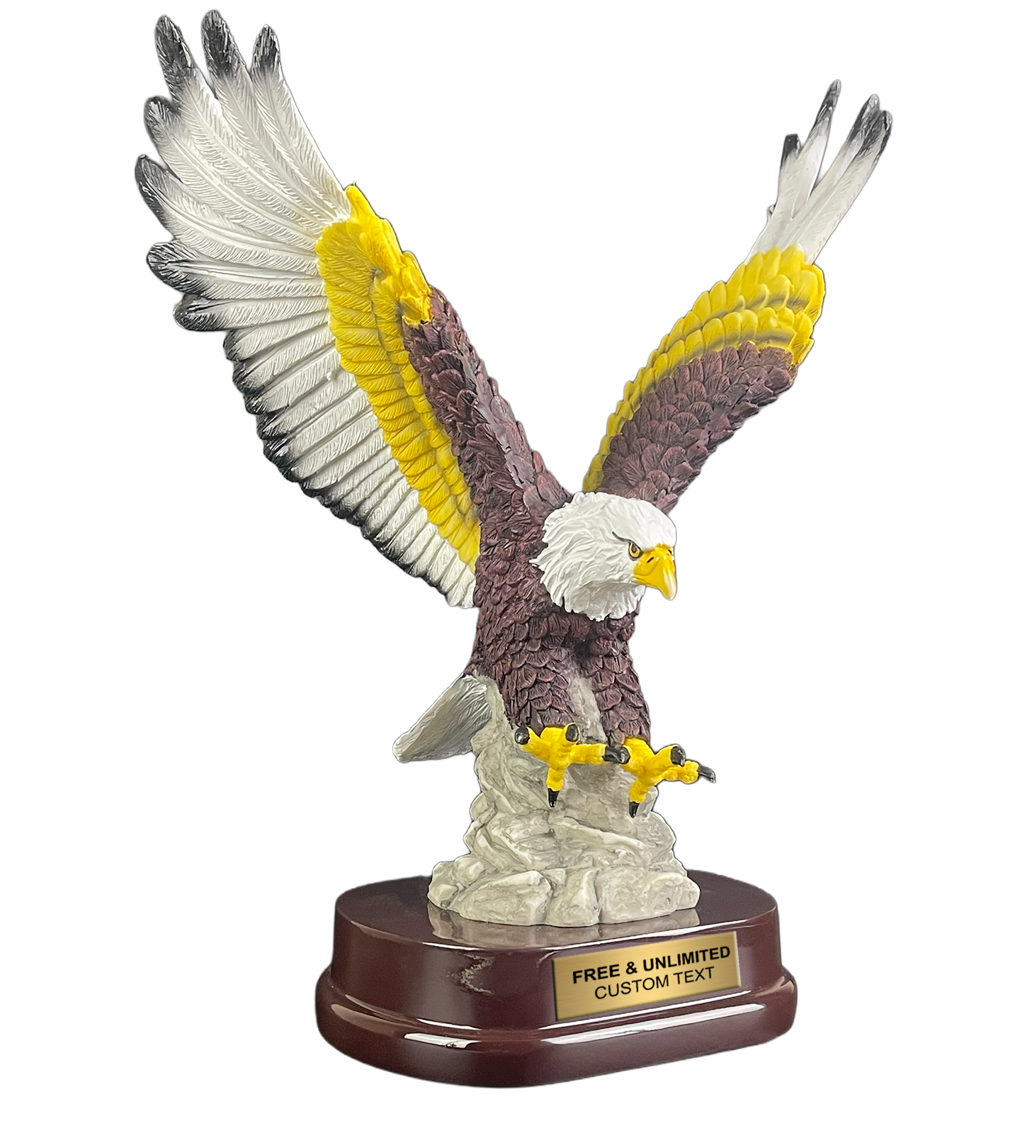 A bald eagle figurine with wings spread, featuring a white head and tail, brown body, yellow wing accents, and yellow talons, mounted on a white rock-like base and a dark brown oval pedestal with a gold plaque reading 'FREE & UNLIMITED CUSTOM TEXT'.